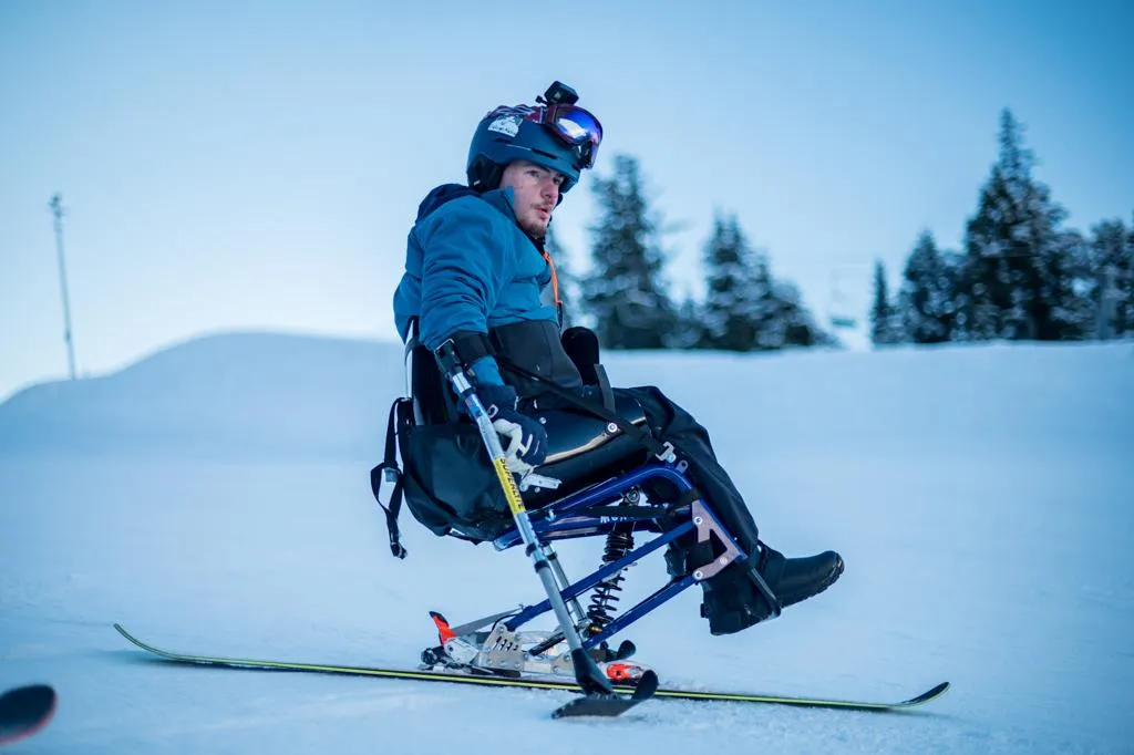 Adaptive athletes and volunteers smiling at an outdoor event